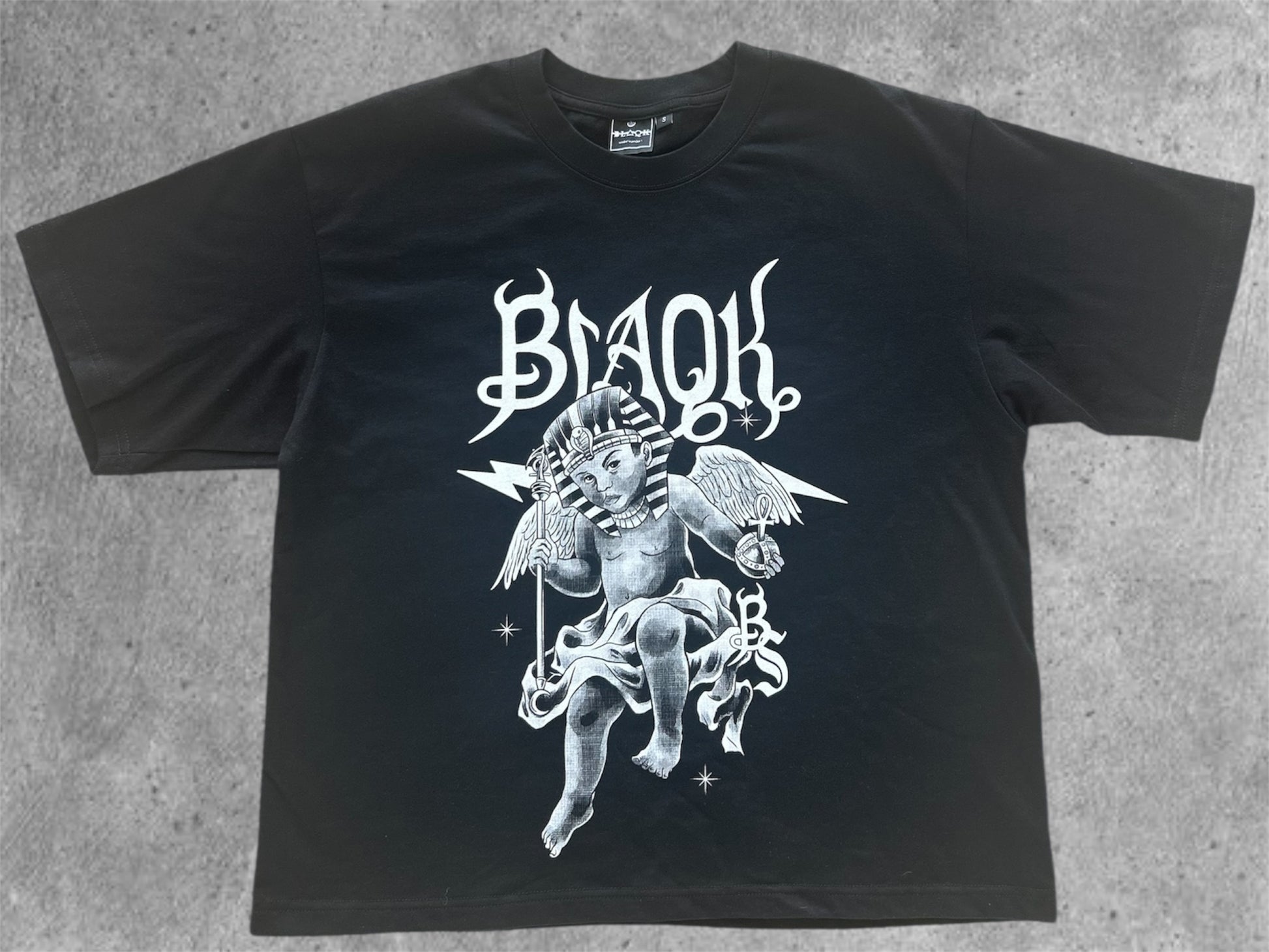 Angel inspired by Heru and King Tut holding royal regalia on Born to Reign tee, Aboriginal streetwear.